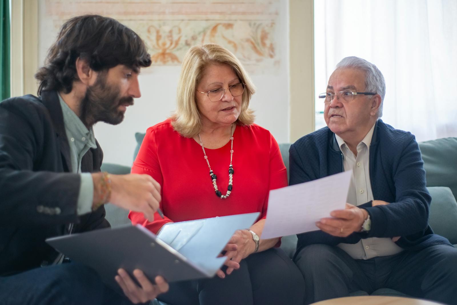 A HUD-approved counselor talking through the loan with an elderly couple